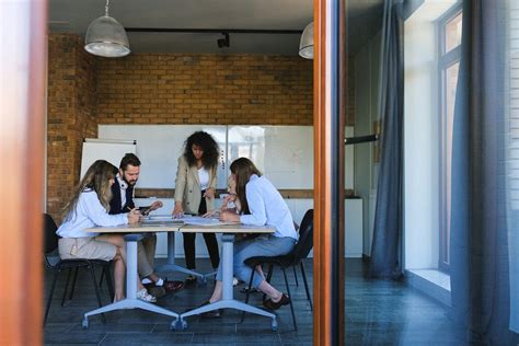 Diverse Businesspeople Talking In Modern Conference Hall · Free Stock Photo