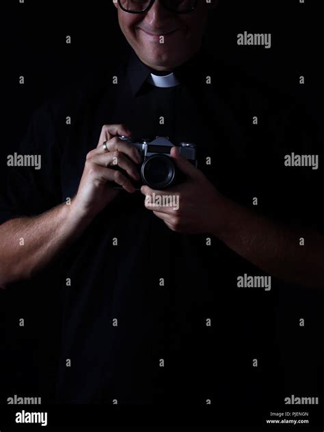 Smiling Priest With The Camera Stock Photo Alamy