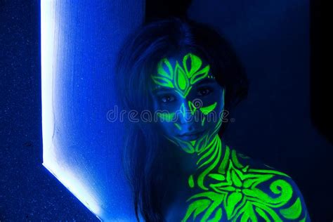 Body Art On The Body And Hand Of A Girl Glowing In The Ultraviolet