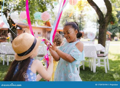 Small Children Outdoors In Garden In Summer Playing Stock Photo