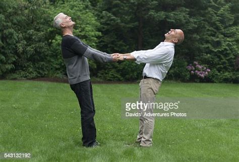 Senior Gay Couple Affectionately Laughing And Twirling Each Other In