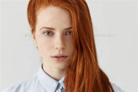 beauty and hair care concept close up shot of beautiful redhead girl with perfect clean skin