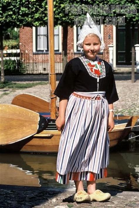A Dutch Girl With Traditional Costume The Strips Of The Dress Are Also The Color Of Dutch Flag