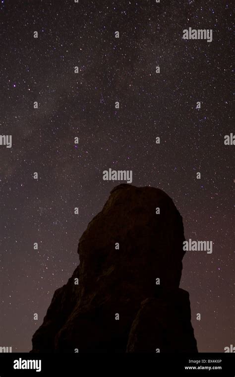 Silhouette Of Monolithic Volcanic Rock Formations And Night Sky Stars