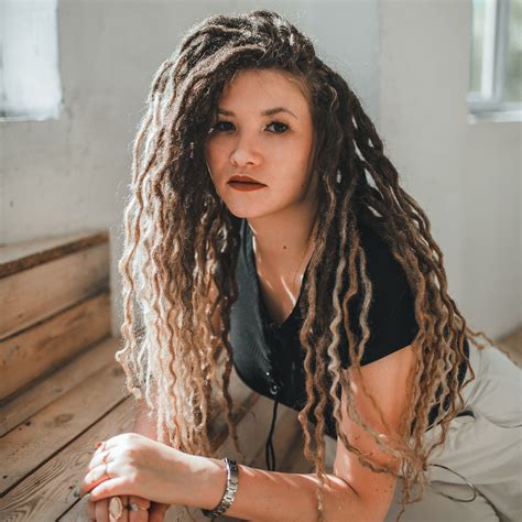 The girl in the photo has a Full Set of 55 DE Dreads, Length 2022