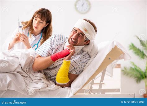 The Young Doctor Examining Injured Patient Stock Photo Image Of