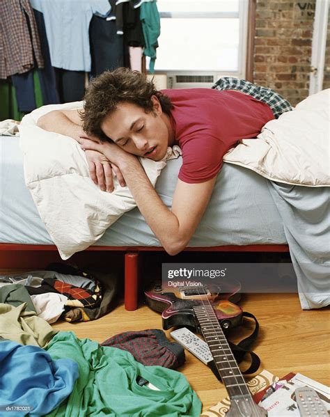 Scruffy Thirty Something Man Sleeping On A Bed In A Untidy Bedroom High