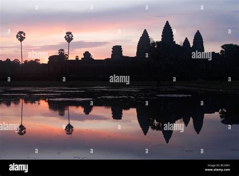 Angkor Wat Temple Silhouette Of Ruins And Beautiful Sky Reflected In