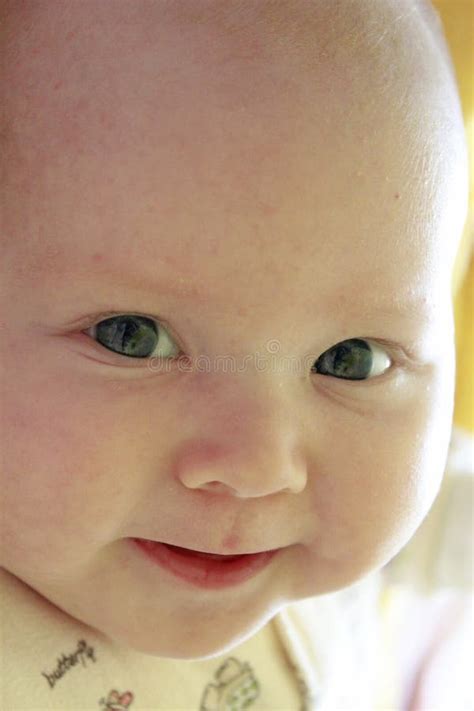 Portrait Of Smiling Baby With Blue Eyes Newborn Child Looking At
