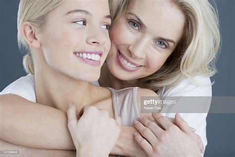 Close Up Portrait Of Smiling Mother And Daughter Hugging High Res Stock