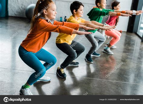 Preteen Kids Doing Squats Gym Together — Stock Photo © Allaserebrina