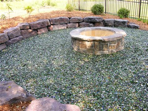 Use your level to make sure your stones are at the same height. Shimmering Glass Surrounds the Fire Pit in this Backyard ...