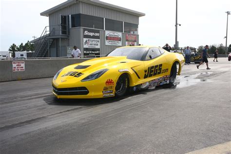 A Yellow Sports Car Is On The Track