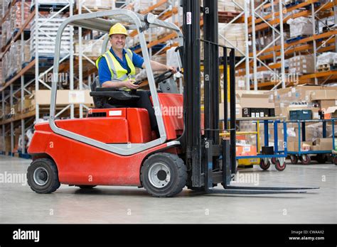 Man driving forklift truck Stock Photo - Alamy