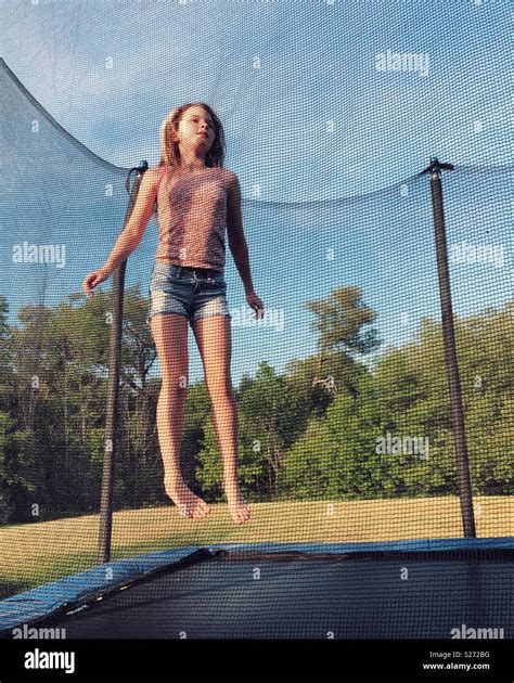 Tween Girl Jumping On A Trampoline Stock Photo Alamy