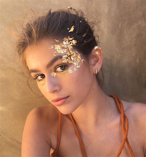Glitterpot including mixtures of glittery holographic gold stars, diamonds circles and gold glittery magical dusthow to apply: Kaia Gerber's Best Hair and Makeup Looks | Teen Vogue