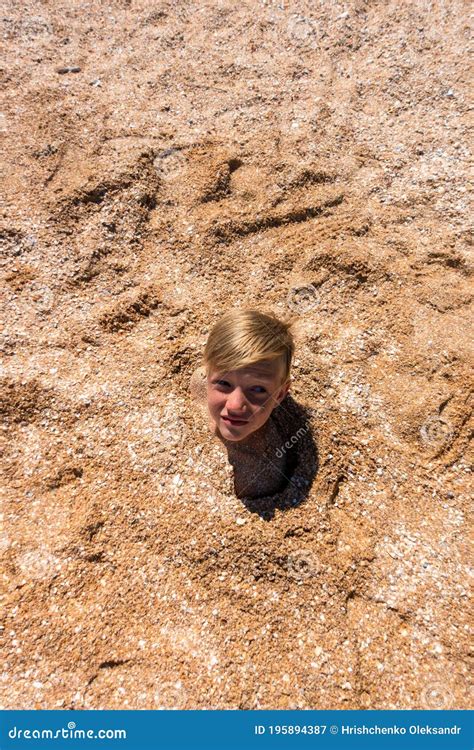 The Boy S Head Is Sticking Out Of The Sand Stock Image Image Of