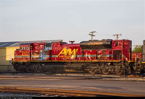 A Red And Yellow Train Is On The Tracks