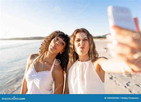 Beautiful Mixed Race Female Love Couple Making Faces Doing Self Portrait On Beach Two Lesbian