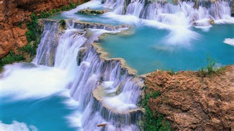 Multiple Waterfalls Pouring On River Surrounded By Rocks Hd Nature