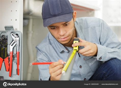Young Tradesman Measuring Pvc Pipe Stock Photo By ©photography33 386550490