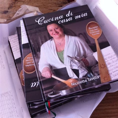 Three Cookbooks Are Stacked On Top Of Each Other With Utensils In Front