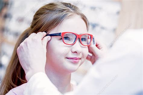 Optometrist Trying Glasses On Girl Stock Image F018 2838 Science Photo Library