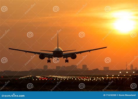Airplane Is Landing During Sunrise Stock Photo Image Of Light