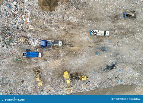 Garbage Pile In Trash Dump Or Landfill Dump Trucks And Excavators