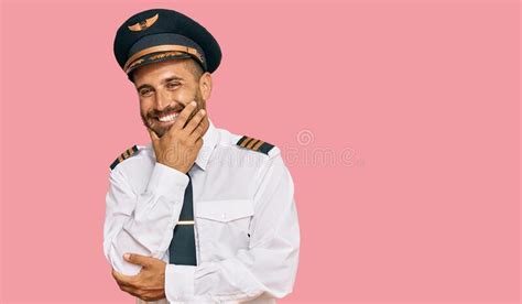 Handsome Man With Beard Wearing Airplane Pilot Uniform Looking