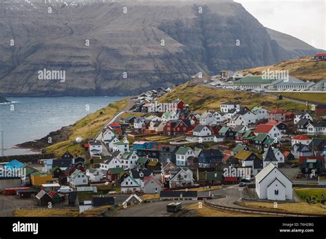 View Onto The Village Eiði With Its Colourful Houses And The Church Of