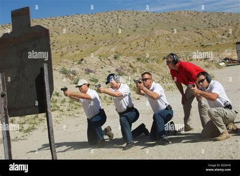 Men Firing Guns At Shooting Range Stock Photo Alamy