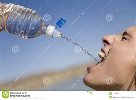 Woman Squirting Water Into Mouth Stock Photography Image
