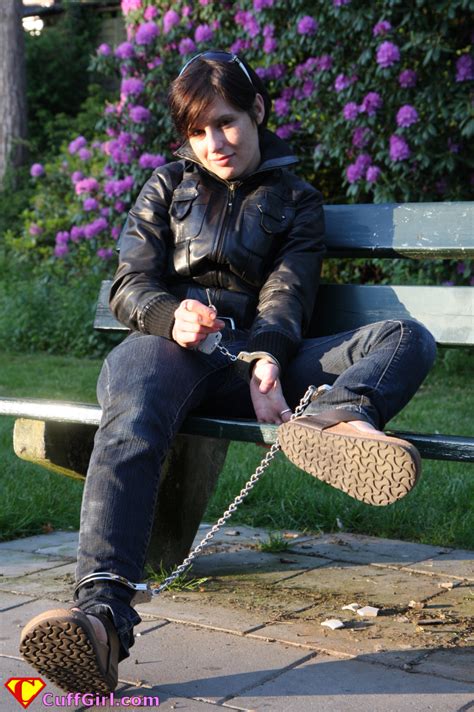 Woman Takes A Rest At Her Afternoon Walk In Handcuffs And Leg Irons