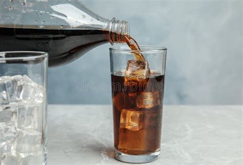 Pouring Refreshing Soda Drink Into Glass On Table Stock Photo Image