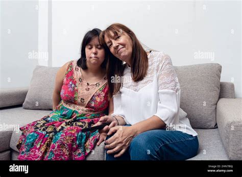 Caucasian Hispanic Latina Mom And Daughter Together Sitting On A Sofa