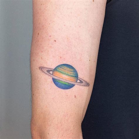 Hand Poked Saturn Tattoo Placed On The Upper Arm