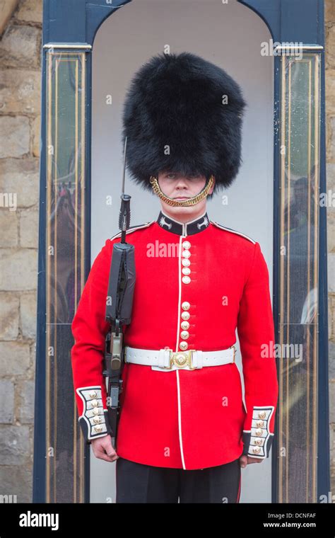 Soldier In Queens Guard At Windsor Castle England With Red Uniform