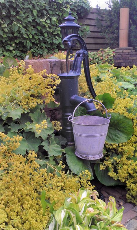 On old worn wooden pole. Handy to have an old fashioned water pump in the garden ...