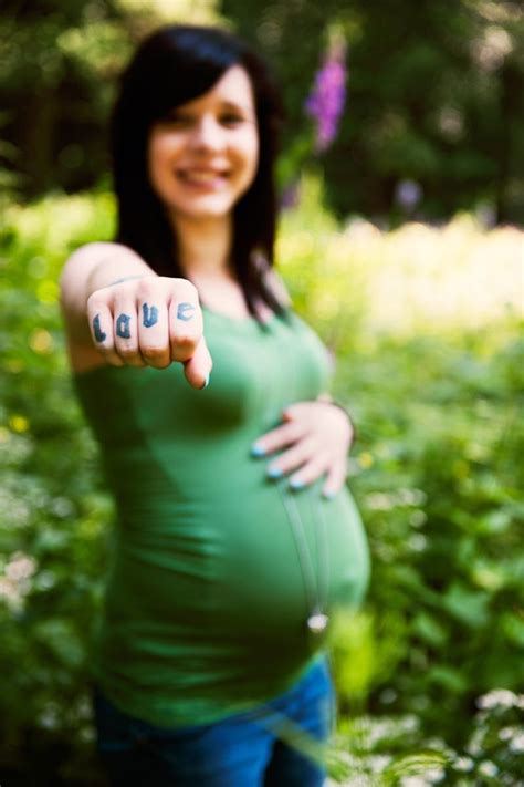 a pregnant woman pointing her finger at the camera
