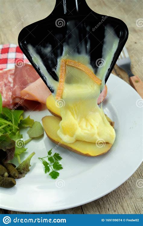 Raclette Cheese And Cold Meats On A Table Stock Photo Image Of