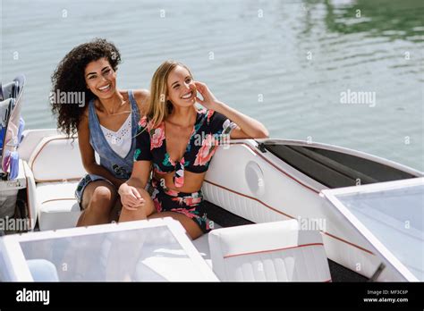 Marbella Two Multiracial Women Having Fun Boat Port Lifestyle Concept