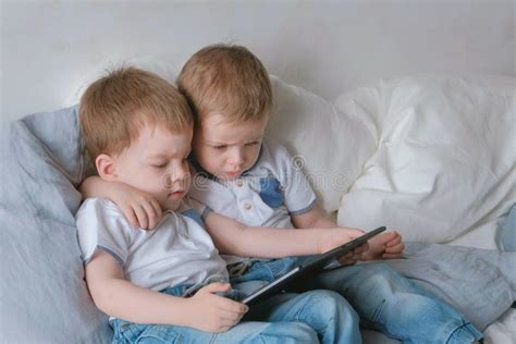 Kids With Tablet Two Boys Twins Toddlers Looking Cartoon At Tablet
