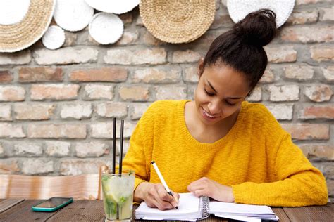 Beautiful Young Black Woman Writing Notes At Cafe Laura Henry Writes