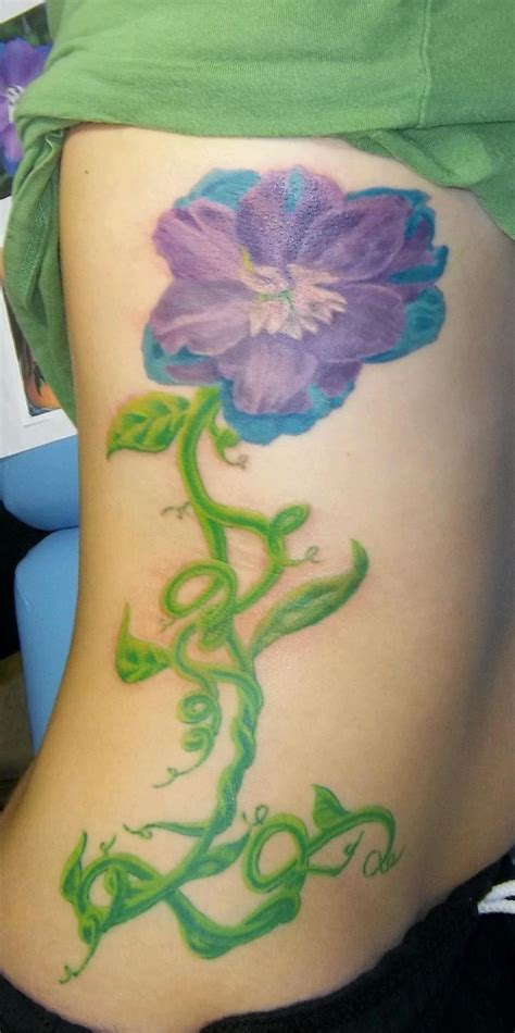 A Womans Stomach With A Flower Painted On It