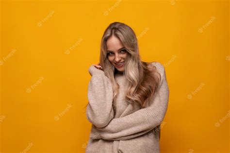 Premium Photo Photo Of Shy Blonde Girl On Yellow Background