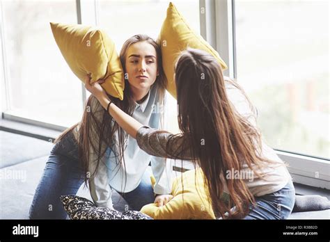 Two Beautiful Young Twins Sisters Spending Time Together With Pillows