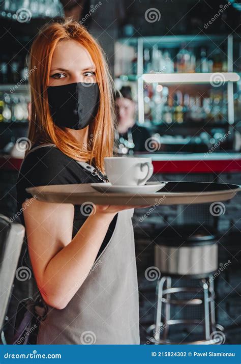 Young Waitress Standing In Cafe Girl The Waiter Holds In Bunches A