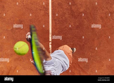 Top view of a professional female tennis player serves the tennis ball