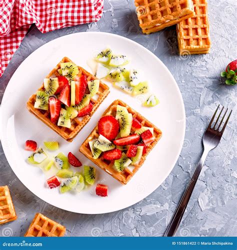 Belgian Waffles With Fruits Strawberries And Kiwi On White Plate